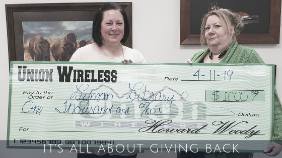 Two Women Holding a Big Check